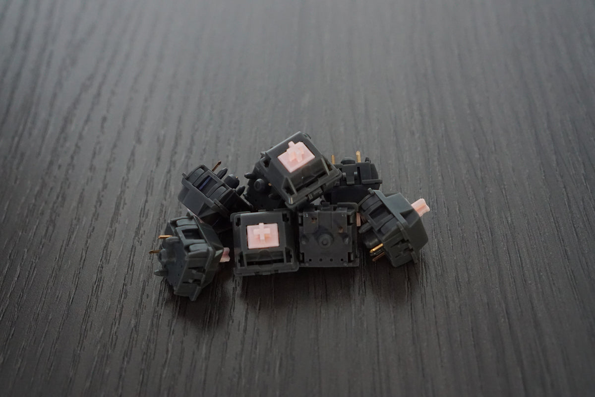 Official PrimeKB Alpaca linear switches with dark housings and pale pink stems
